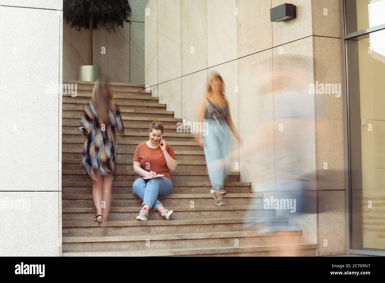 Manager, paperwork. Caucasian inclusive plus-size model in daily routine. Realness, tolerance. Her lifestyle is the same like of other people. Concept of wellness, inclusion, diversity, human rights. Stock Photo