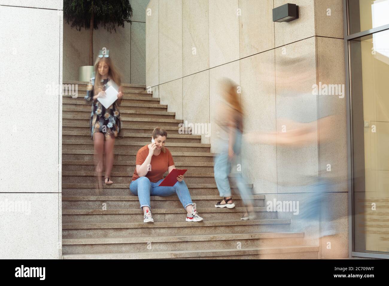 Remote working. Caucasian inclusive plus-size model in daily routine. Realness, tolerance. Her lifestyle is the same like of other people. Concept of wellness, inclusion, diversity, human rights. Stock Photo