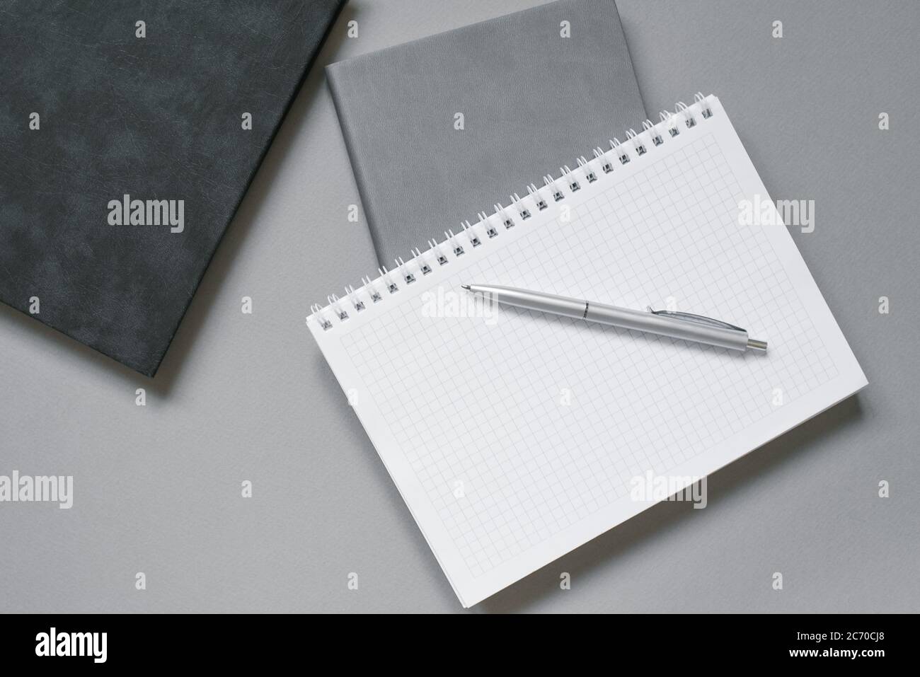 Notebooks or diaries with a blank page and a ballpoint pen on top of them. Office worker's place Stock Photo