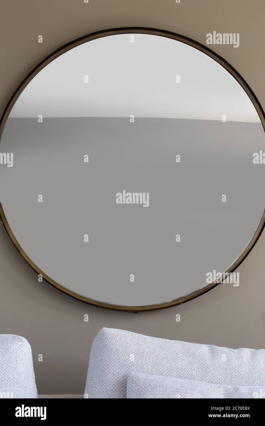 Big round mirror in living room modern interior, retro luxury oval