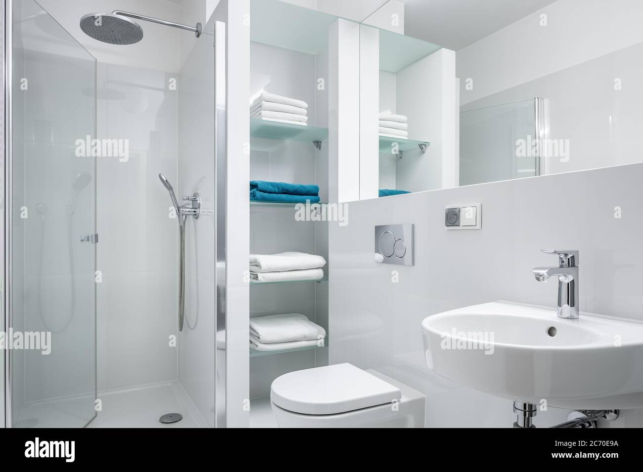 Simple designed white bathroom with shower and classic washbasin Stock Photo