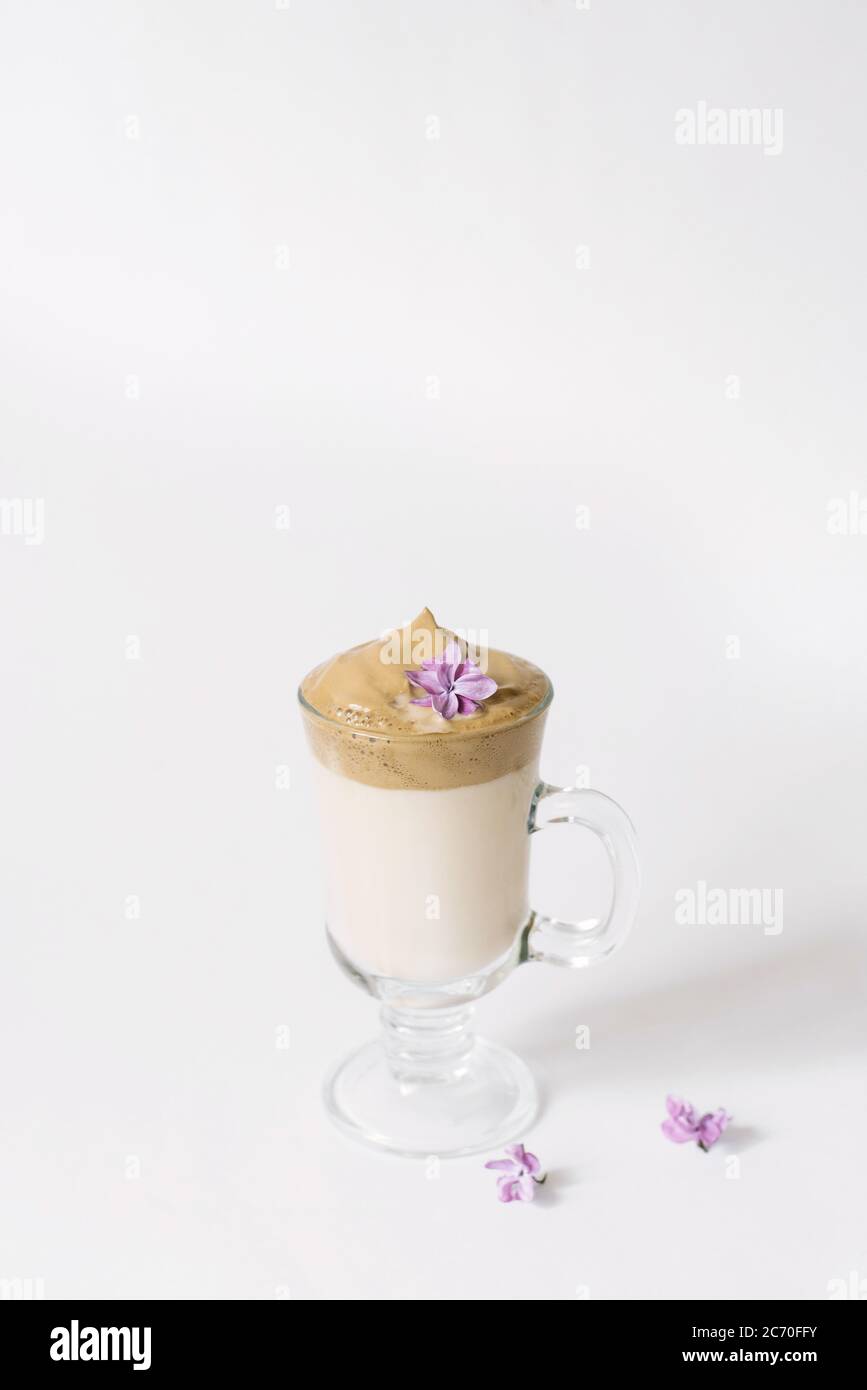 Dalgon's trending drink is coffee. Coffee mug, lilac and marshmallow on a white background. Stock Photo