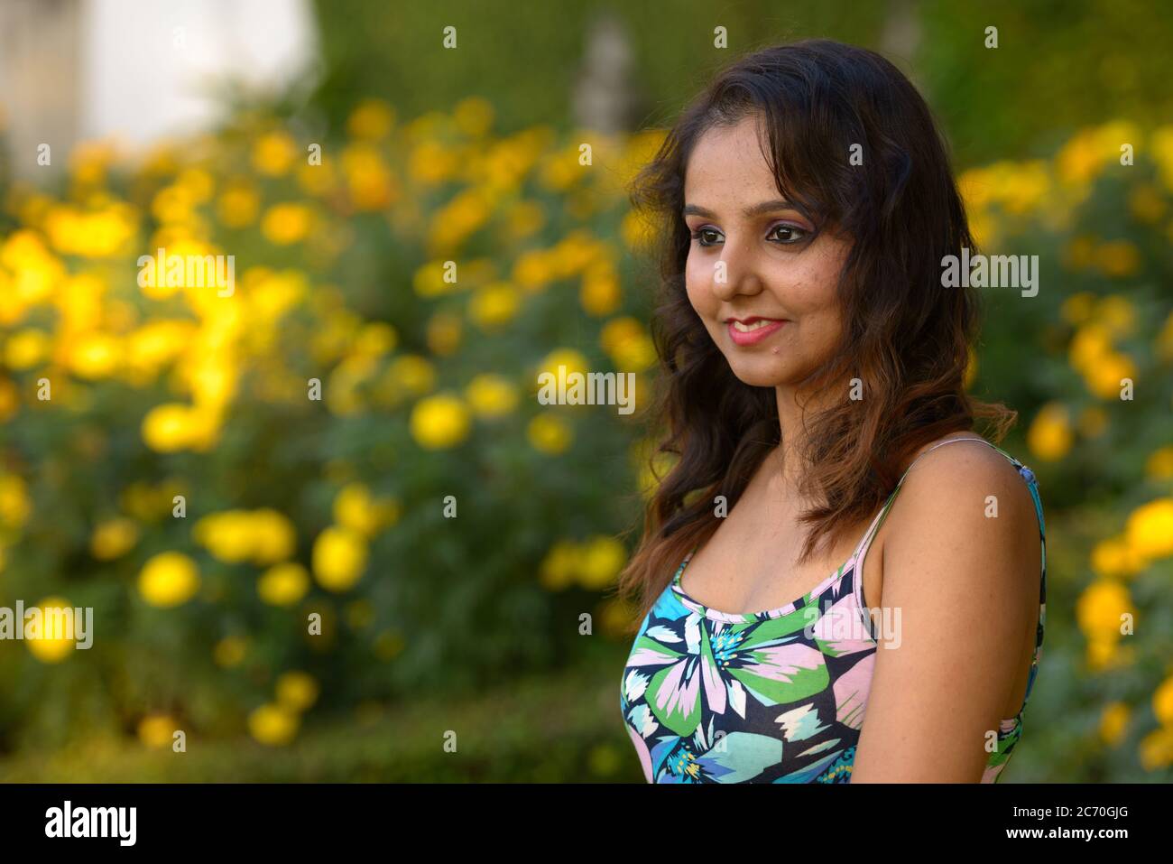 Happy young beautiful Indian woman thinking at the park Stock Photo - Alamy