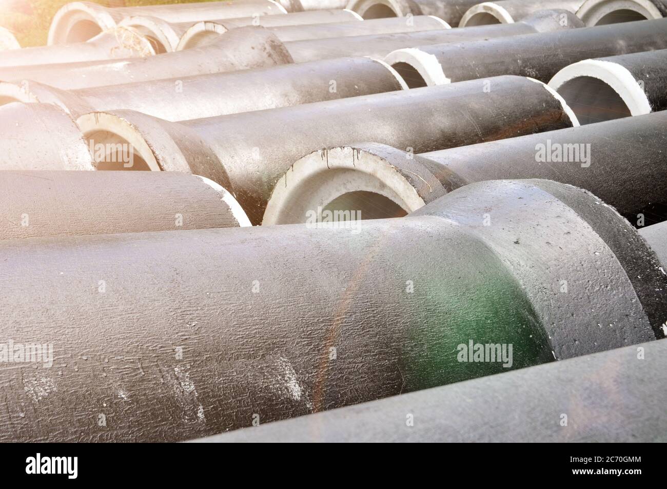 concrete pipes coated with protective mastic at a construction site