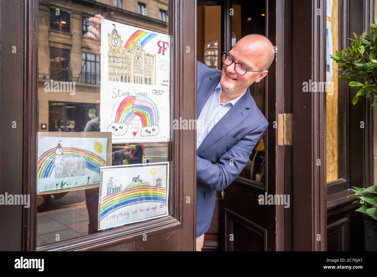 Rob Van Eyck, manager of The Balmoral, Edinburgh, looks at rainbow artwork produced by the children of staff members as the hotels starts to make preparations for re-opening next month as Scotland prepares for the lifting of further coronavirus lockdown restrictions. Stock Photo
