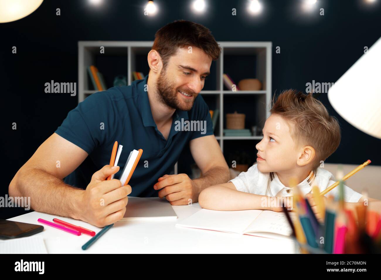 Father helping his little son with school homework Stock Photo - Alamy