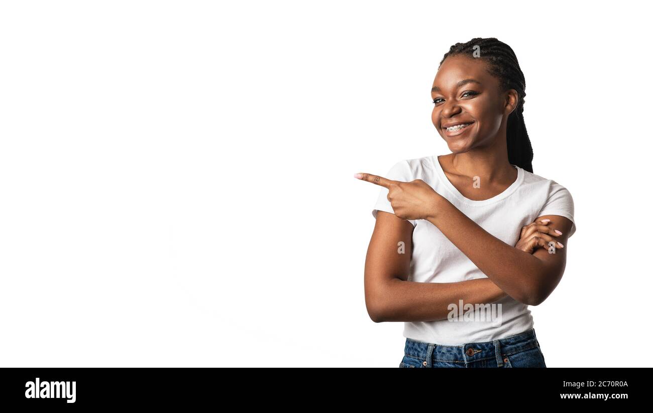 Black Woman In Braces Pointing Finger Aside, White Background, Panorama Stock Photo