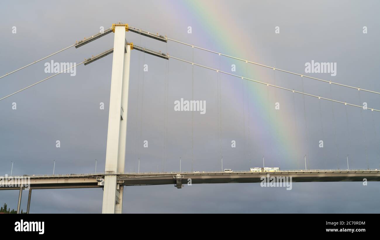 Istanbul, Turkey - March 2020: Bosphorus 15th July Martyrs Bridge over Bosphorus strait under rainbow Stock Photo