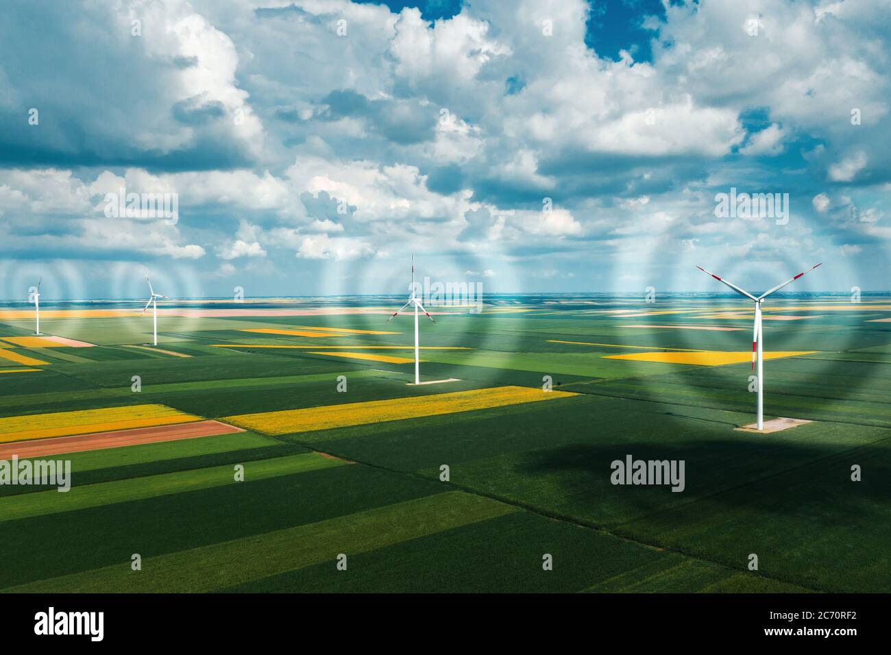 Aerial view of wind turbines on modern wind farm from drone pov, digitally enhanced image high angle view of innovative sustainable resources technolo Stock Photo