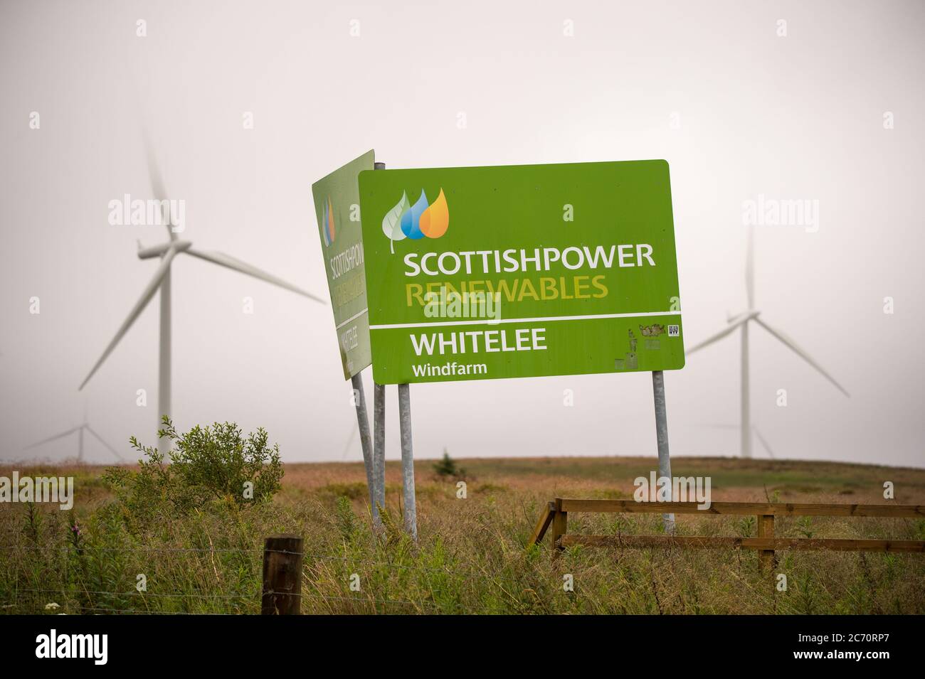 Whitelee, Scotland, UK. 13th July, 2020. Pictured: Scottish Power Renewables wind farm at Whitelee in Ayrshire, seen on a wet and windy day with low cloud masking some of the turbine blades which seem to stick into the low lying cloud. How green are wind turbines? The blades are currently not recyclable, however more investment is needed in order to achieve Scotlands and the UK's green energy targets. Credit: Colin Fisher/Alamy Live News Stock Photo