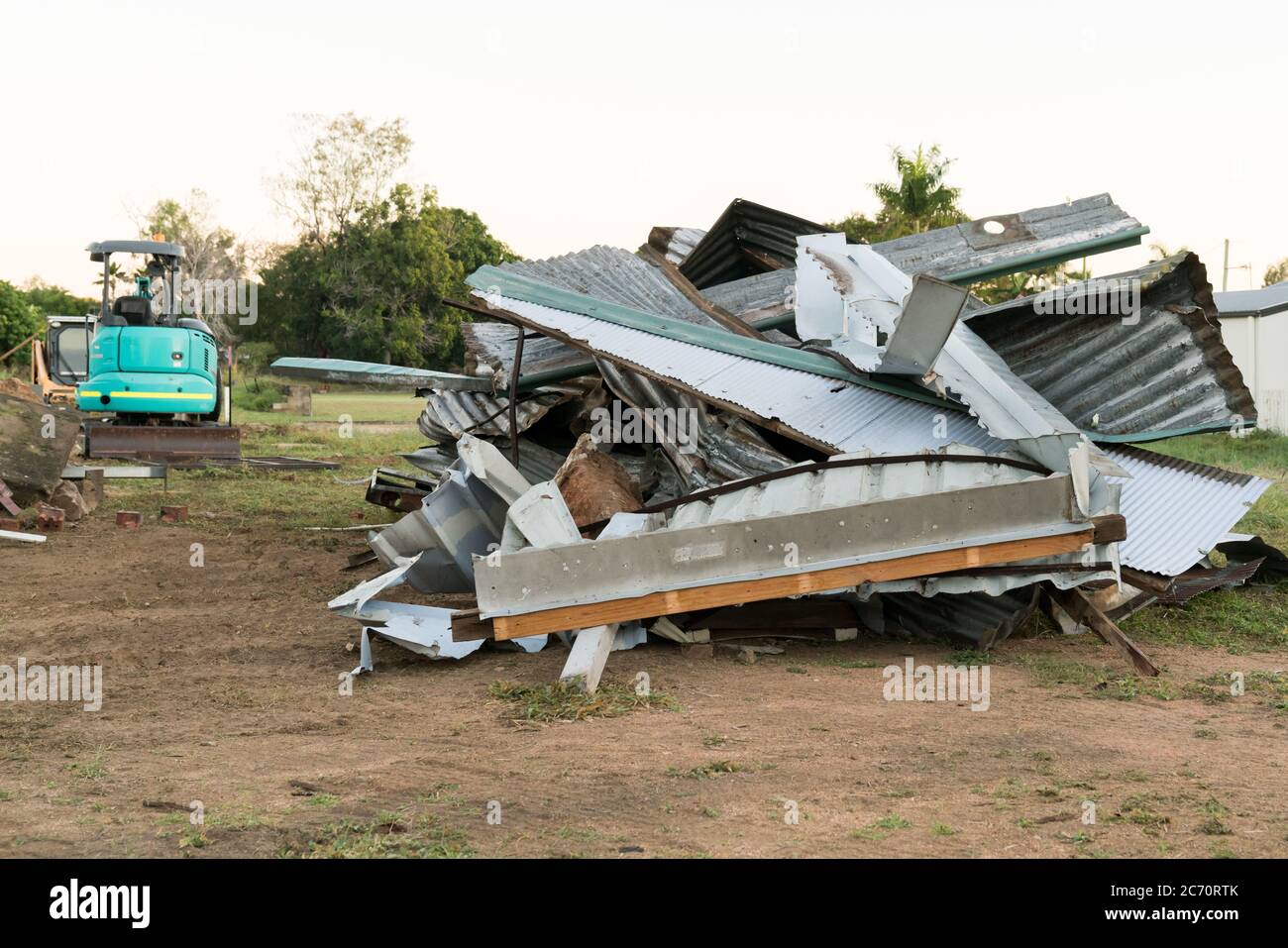 Corrugated iron roof sheeting in pile on building site with machinery Stock Photo