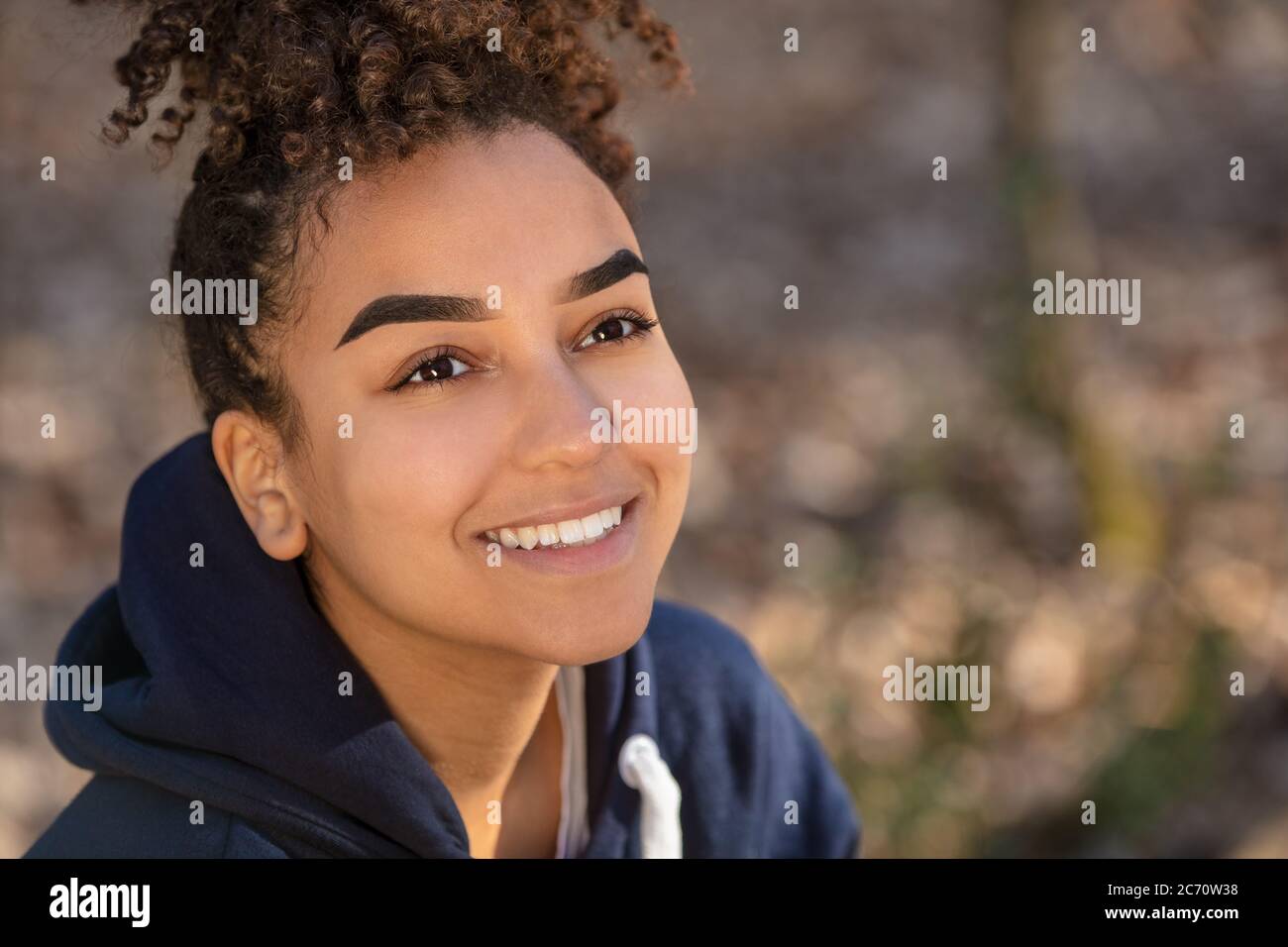 Outdoor portrait of beautiful happy mixed race biracial African