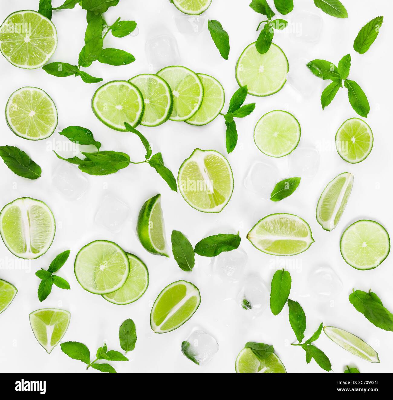 Limes, fresh mint and ice for mojito on white background. Top view. Stock Photo