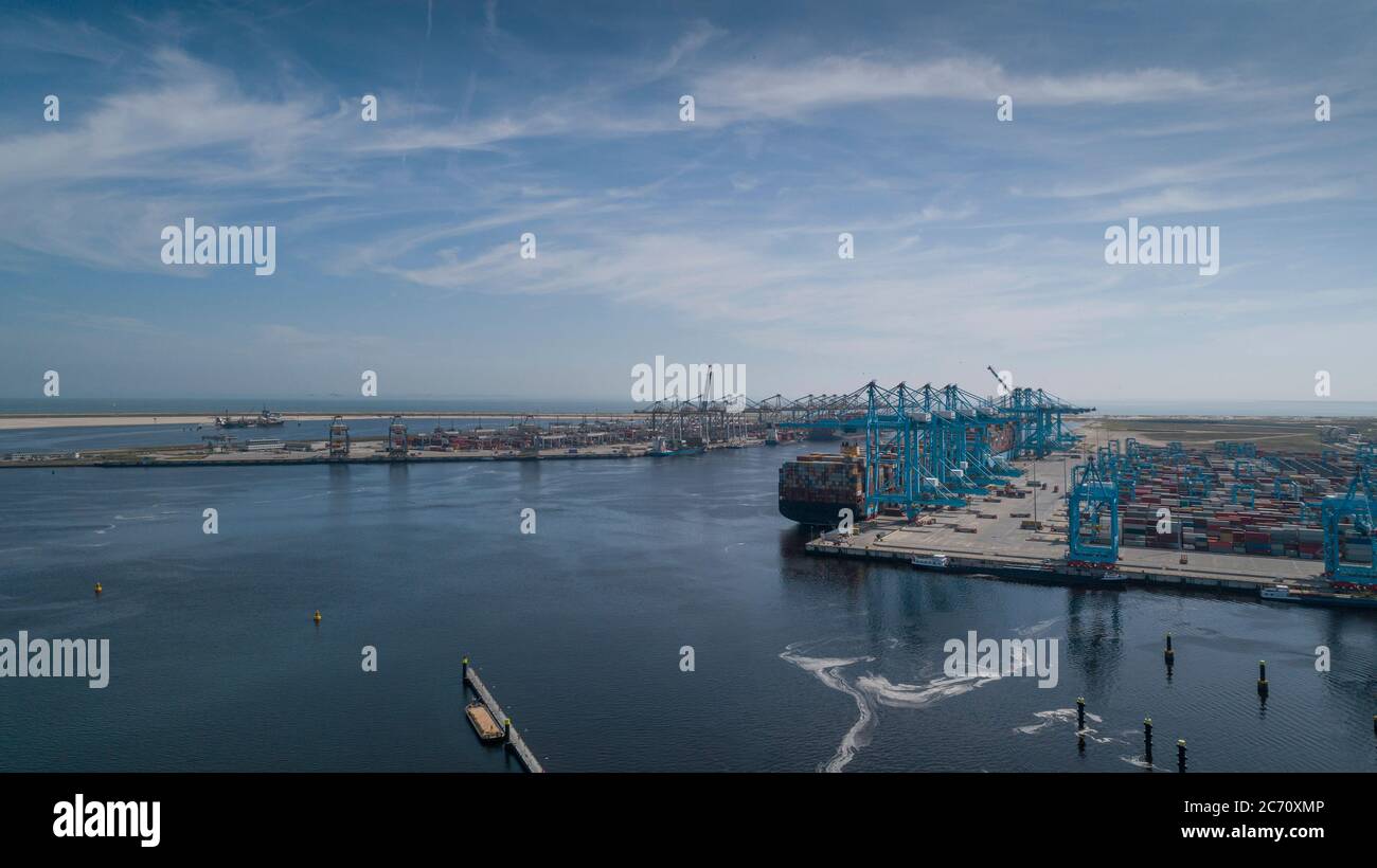 Huge cranes and ships anchored at harbor. International commercial port Stock Photo