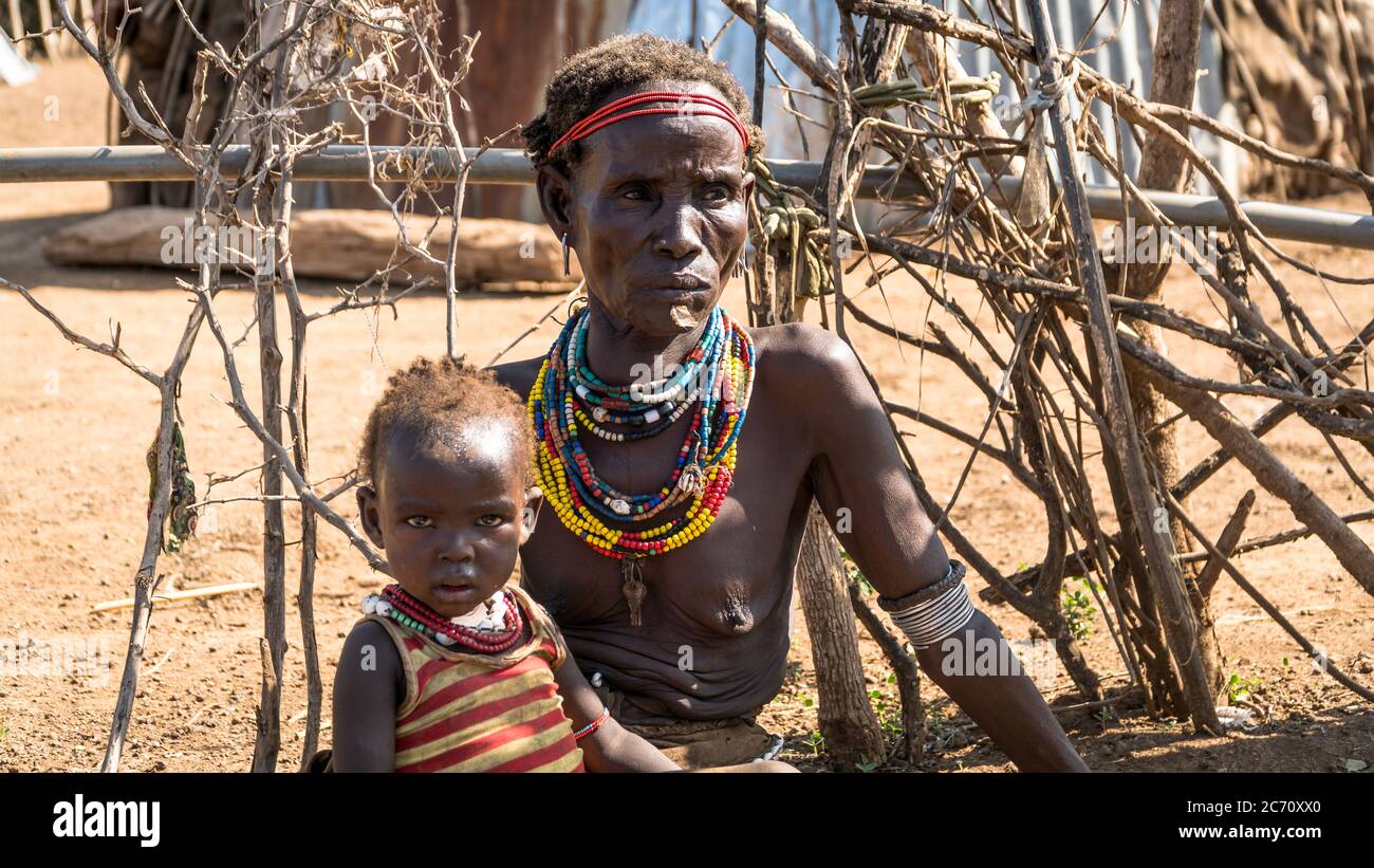 Omorate, Ethiopia - September 2017: Unidentified woman from Dassanech tribe with her child, Ethiopia Stock Photo