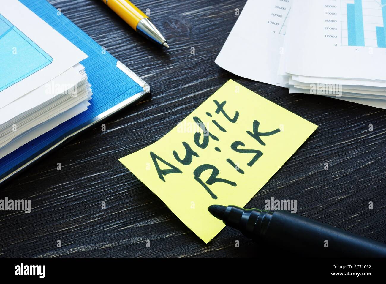 Audit risk memo and stack of papers with report. Stock Photo
