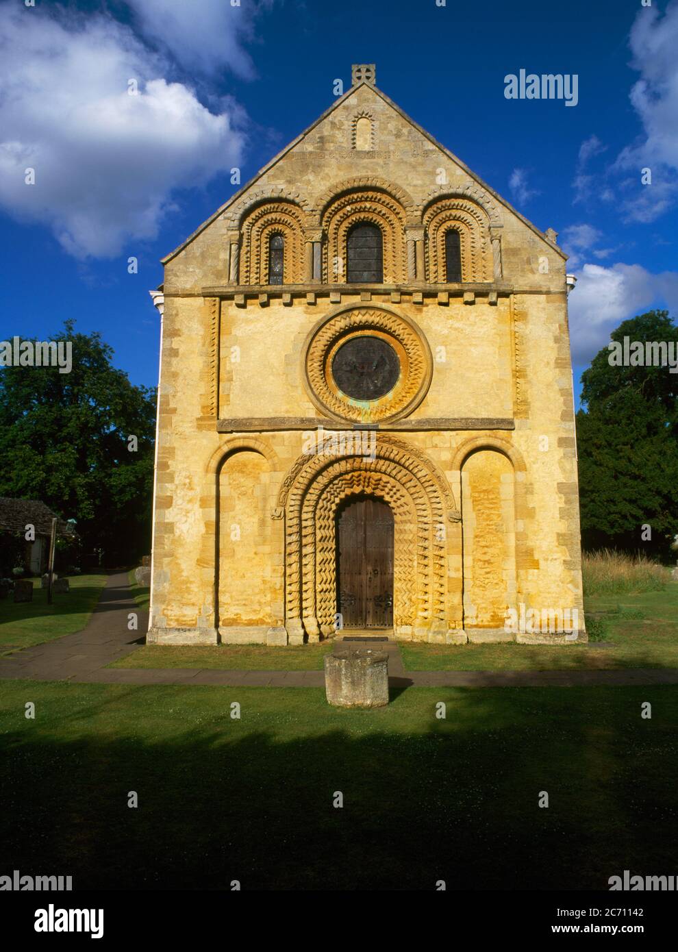 The C12th Romanesque W end of St Mary the Virgin Church, Iffley, Oxford, England, UK, seen in late afternoon sunshine. The facade is richly decorated. Stock Photo