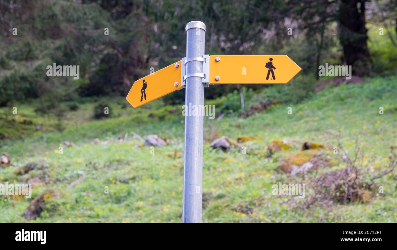 Seealpsee, Switzerland - May 2017: Yellow sign post with mountains in ...