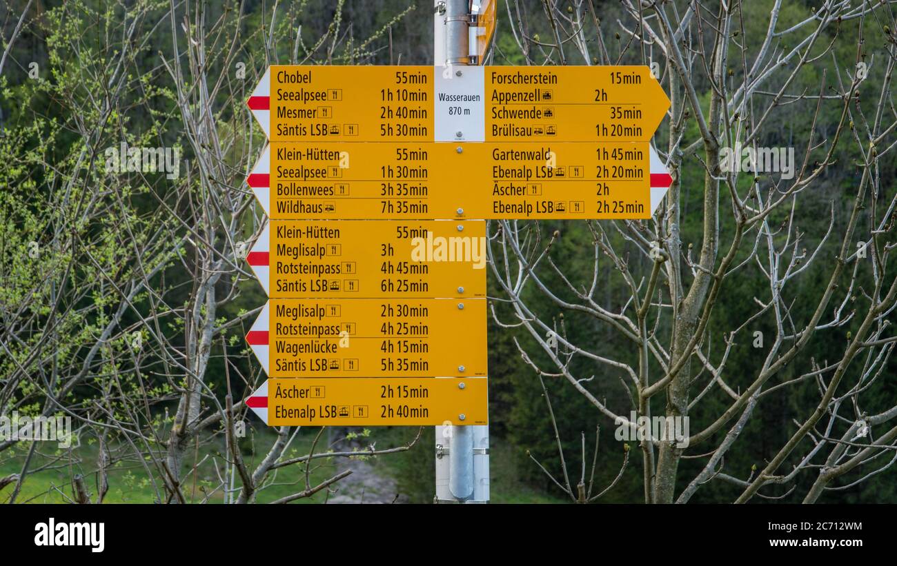 Seealpsee, Switzerland - May 2017: Yellow sign post with mountains in ...