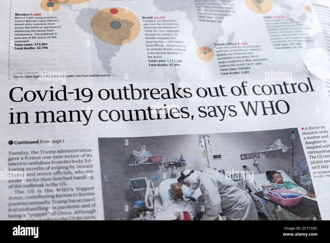 'Covid-19 outbreaks out of control in many countries, says WHO' Guardian article newspaper headline inside page in June 2020 London England UK Stock Photo