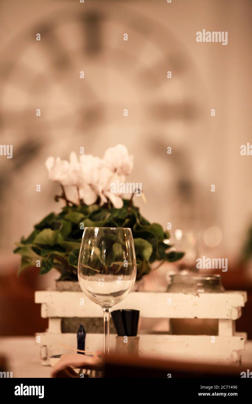 Atmospheric image of a Festive table setting with flowers for a formal dinner Stock Photo