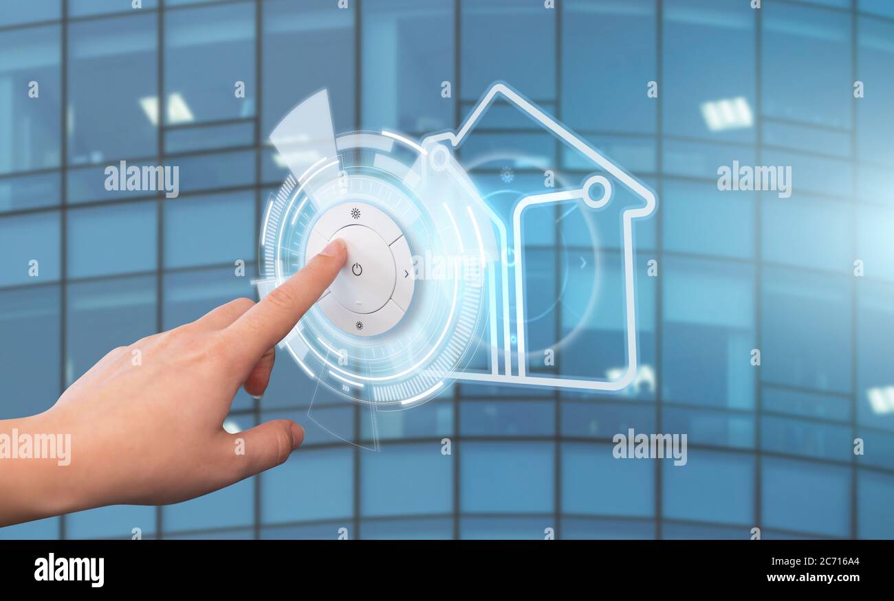 Woman presses a button on the control panel of a smart home. Concept Stock Photo