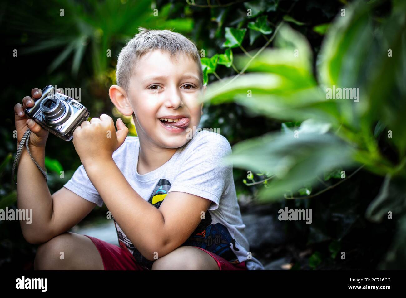 little photographer with his tongue out. concept of youth and carefree. Stock Photo
