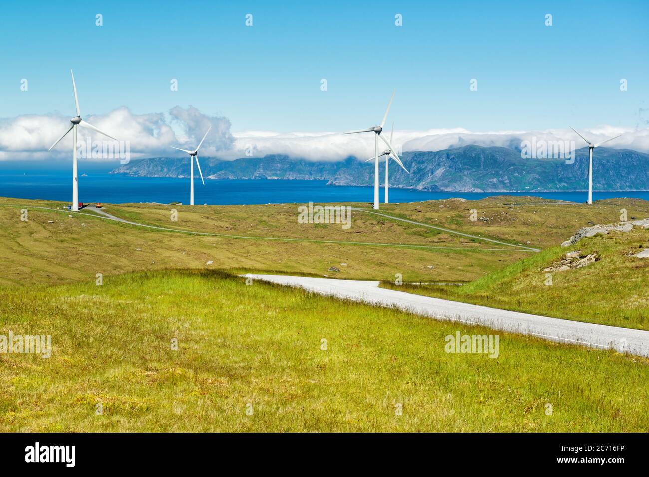 Windmills near the sea producing clean energy at Maloy island, Norway Stock Photo