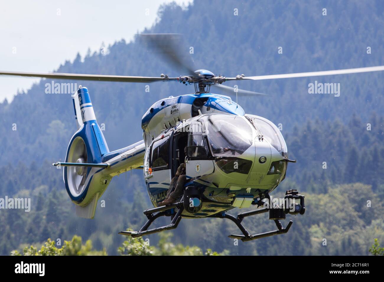 13 July 2020, Baden-Wuerttemberg, Oppenau: A police helicopter lands near  the community of Oppenau on a sports field, which serves as a meeting point  for the police. Because of the police operation