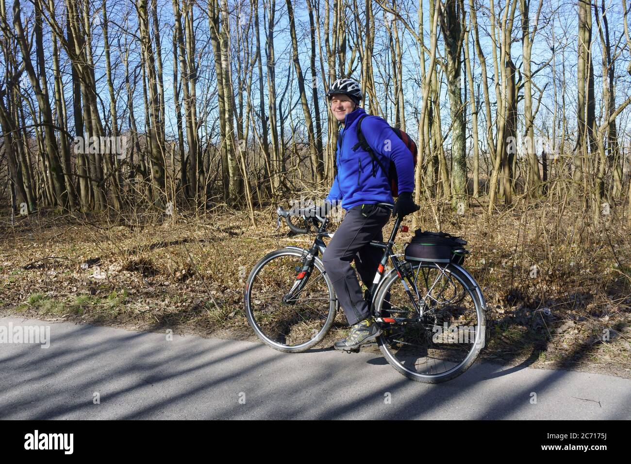Kaliningrad, Russia, March 15, 2020. A man in a helmet on a Bicycle. A cyclist in a blue jacket. Stock Photo
