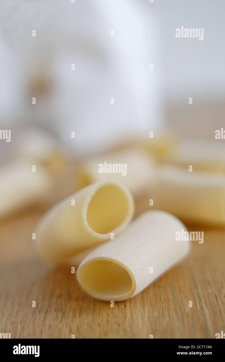 paccheri pasta di gragnano made from italian durum wheat on timber kitchen table top Stock Photo