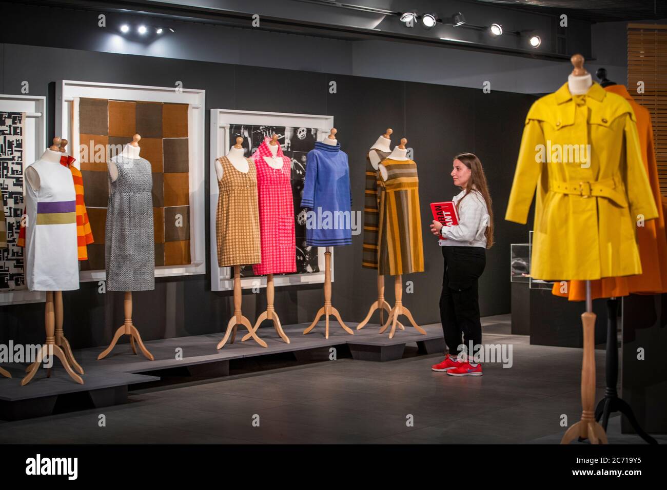 Front of house coordinator Martha Greenbank takes a closer look at designs by British fashion designer Mary Quant that feature in the new exhibition 'Mid-Century Modern: Art & Design from Conran to Quant' at the Dovecot Studios in Edinburgh, which re-opens to the public on Wednesday July 15. Stock Photo