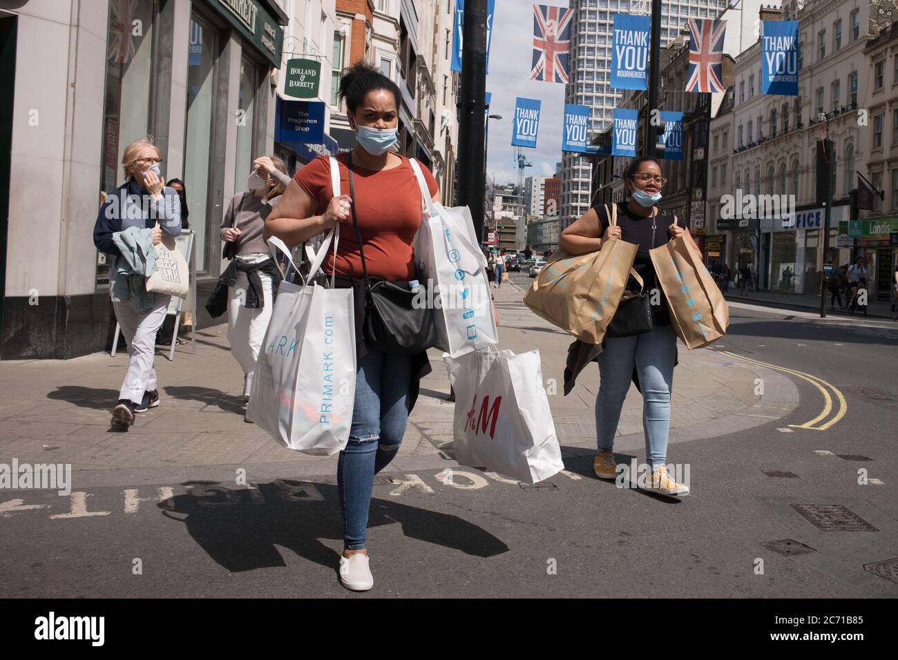 Shoppers on Oxford Street, wearing face masks. Stock Photo