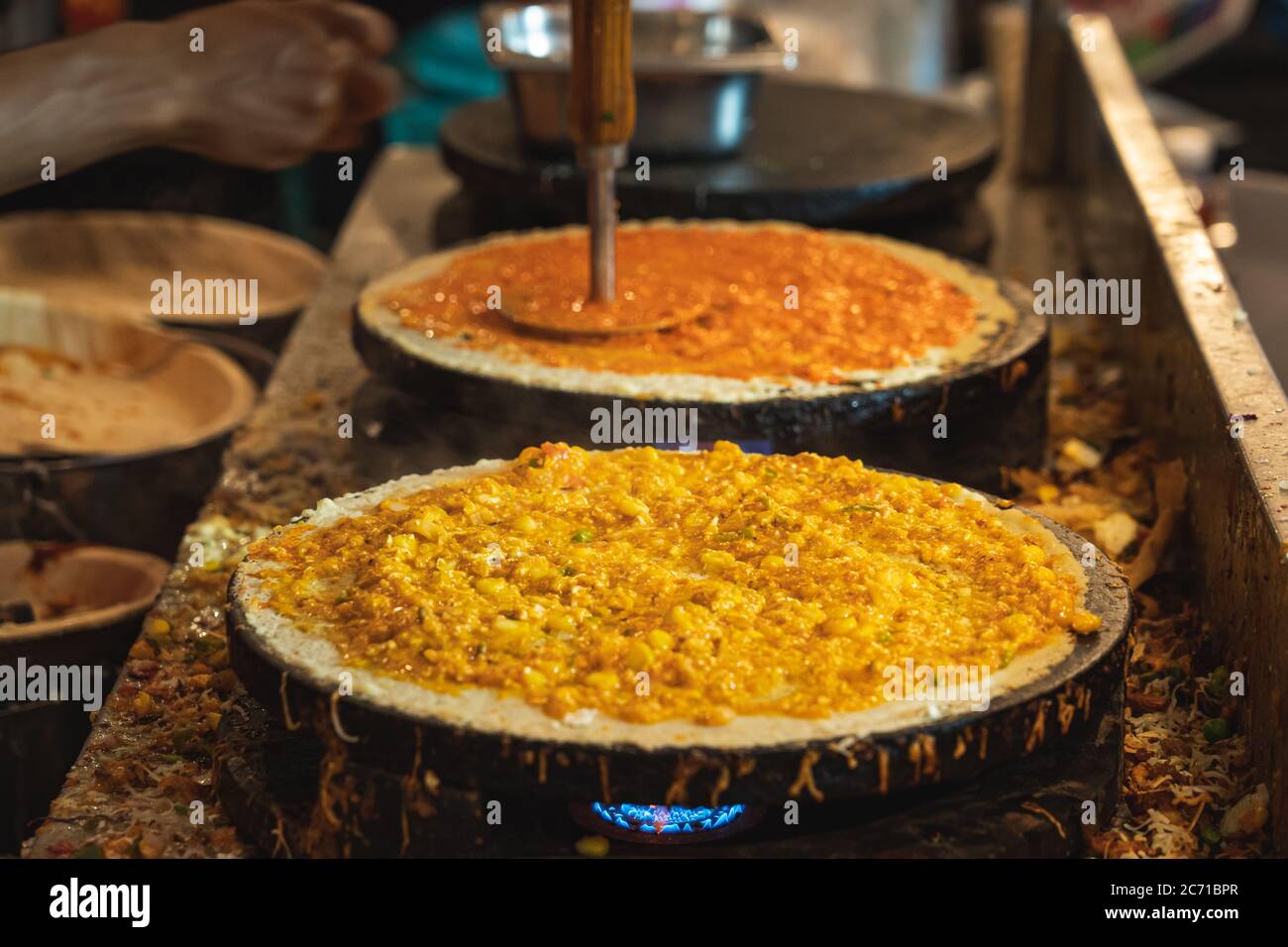 Varieties of dosas cooked in a counter at a food festival Stock Photo