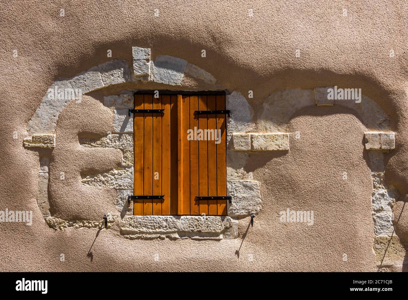 Modern window shutters in old renovated house wall replacing former windows and doorway - Belabre, Indre, France. Stock Photo