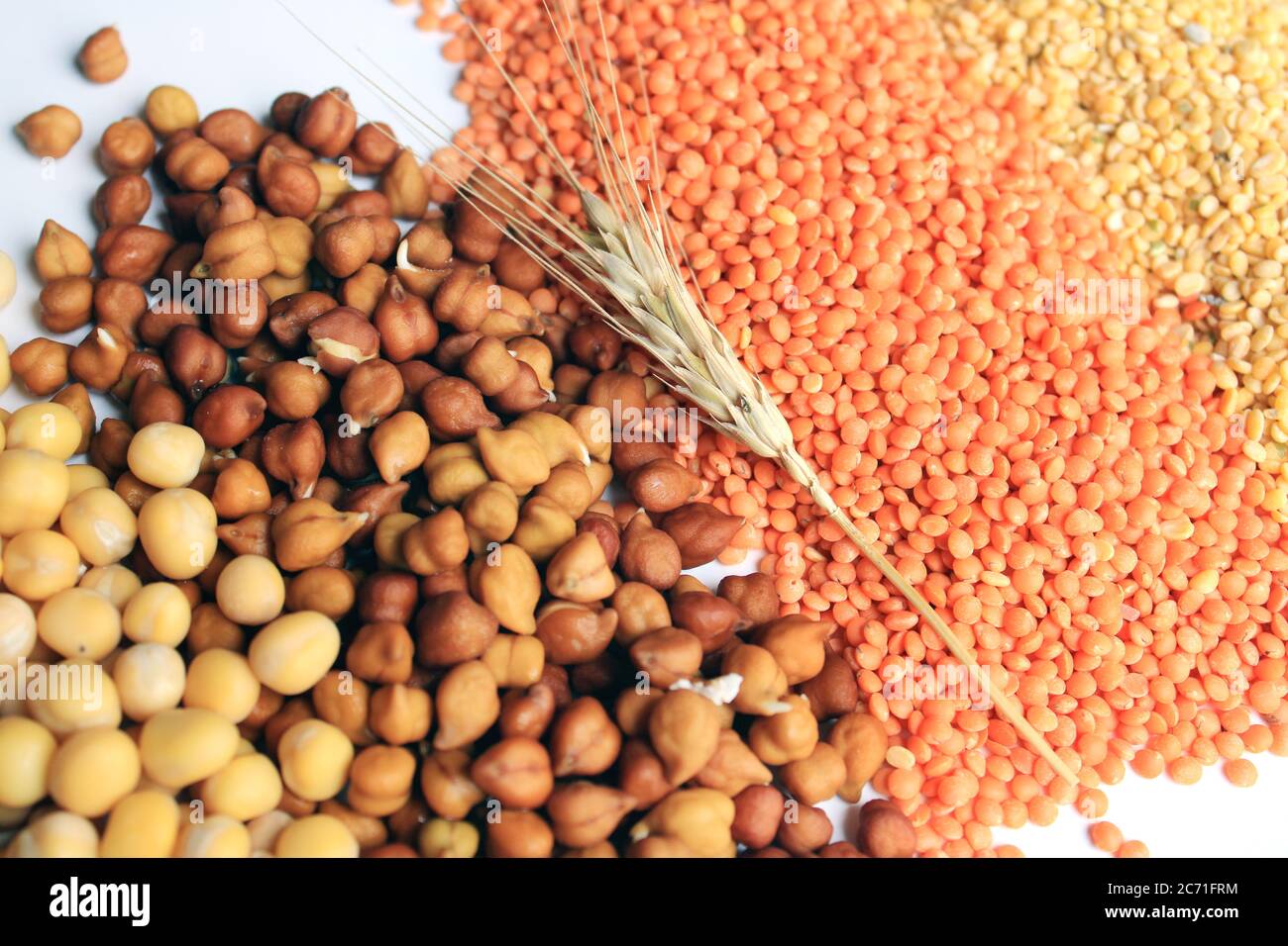 Collection of legumes (chickpeas, green peas, Pink lentils, Dry peas, Pigeon Peas, Red Kidney) isolated on white background. Stock Photo