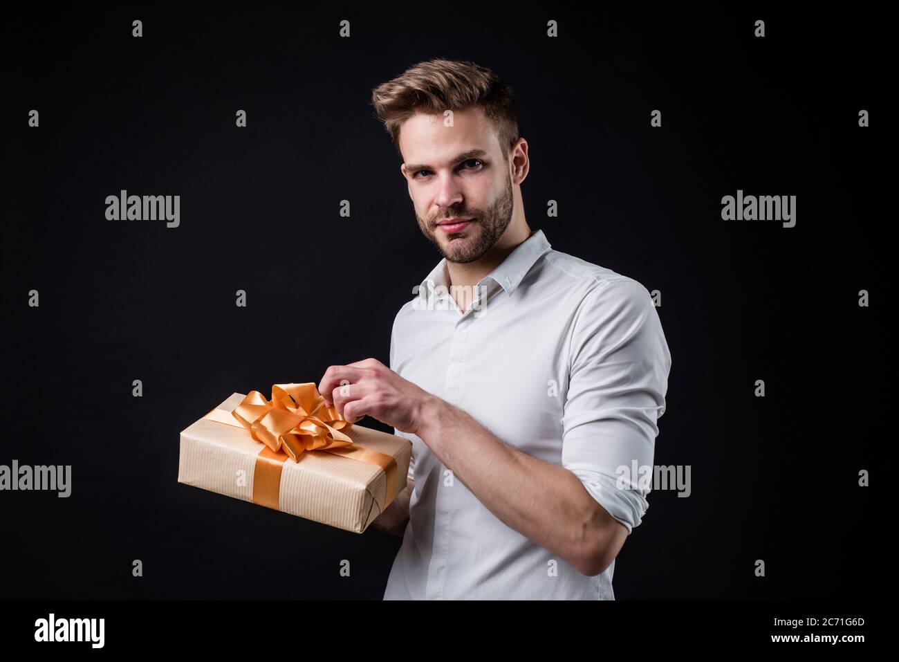 Take it. feel cheer and joy. pure party goer. funny man with gift box. guy hold present. happy holiday celebration. time for fun and presents. happy birthday or anniversary. Stock Photo