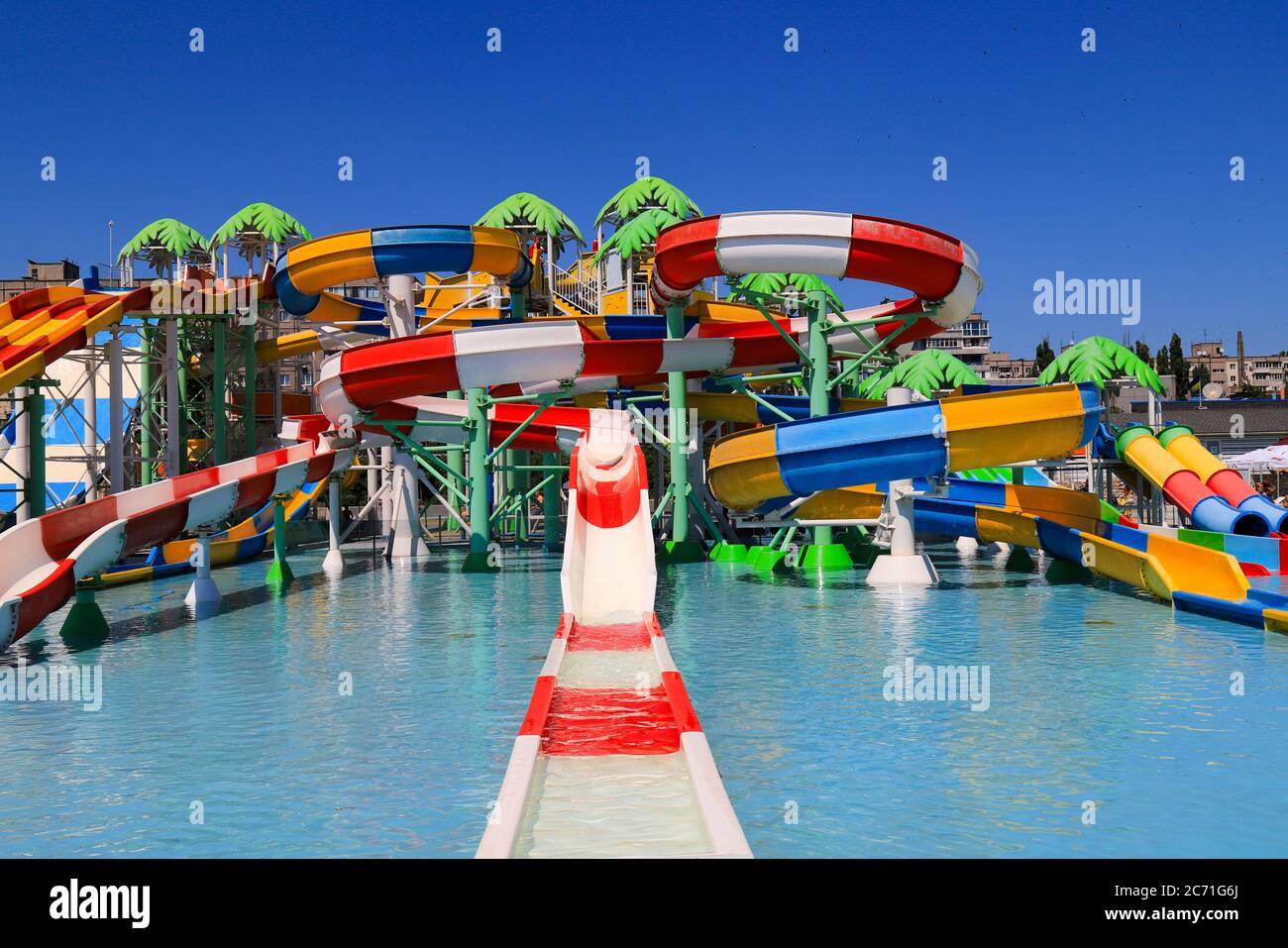 Colorful roller coasters in the picturesque water park. Resort in spring and summer, swimming and sports, active recreation. Dnepropetrovsk Stock Photo