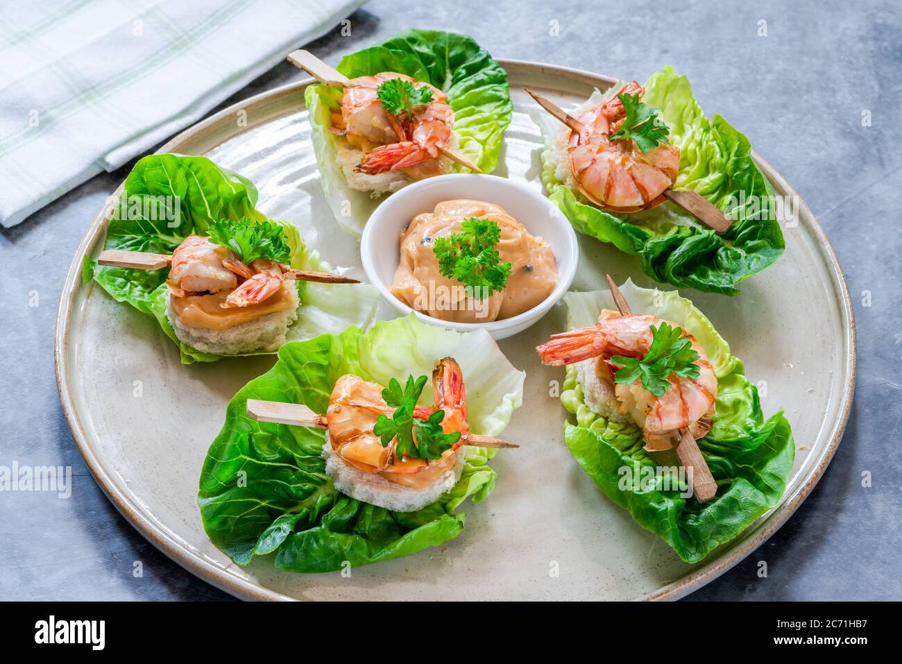 Canapes with grilled black tiger prawns and seafood sauce on fresh