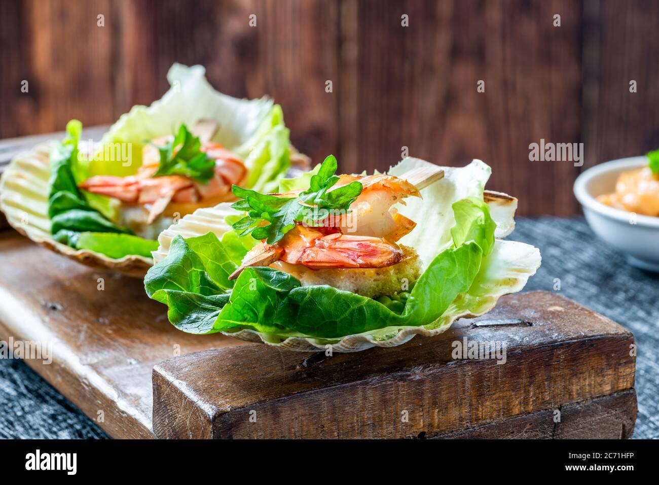 Canapes with grilled black tiger prawns and seafood sauce on fresh