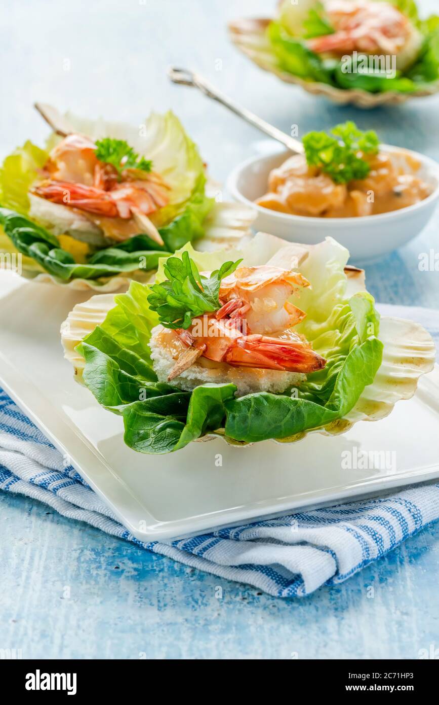 Canapes with grilled black tiger prawns and seafood sauce on fresh