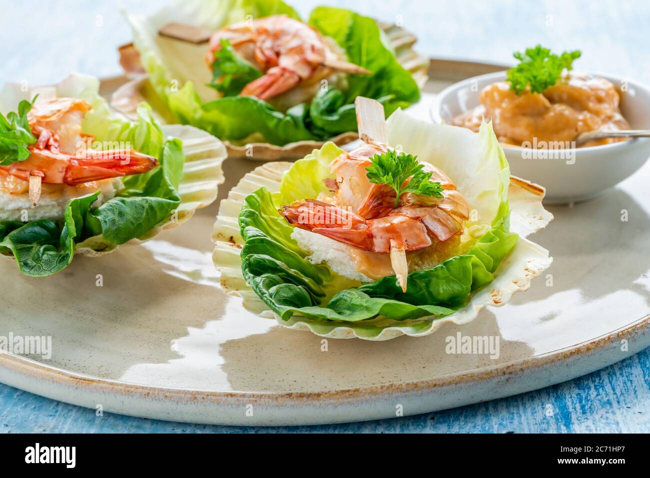 Canapes with grilled black tiger prawns and seafood sauce on fresh
