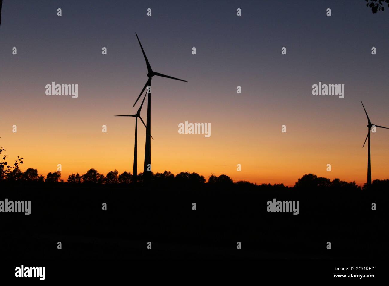 Wind turbines in the sunset near Scheeßel, Lower Saxony, Germany Stock Photo