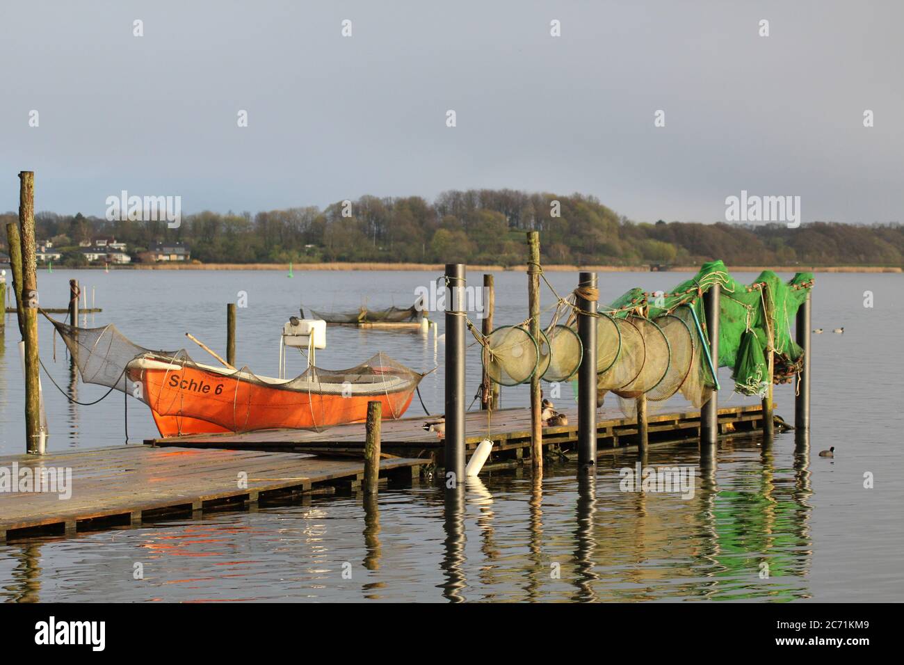 The Schlei is a small inlet of the Baltic Sea, that reaches far into the land; in Schleswig some fishermen are still active with small boats. Stock Photo