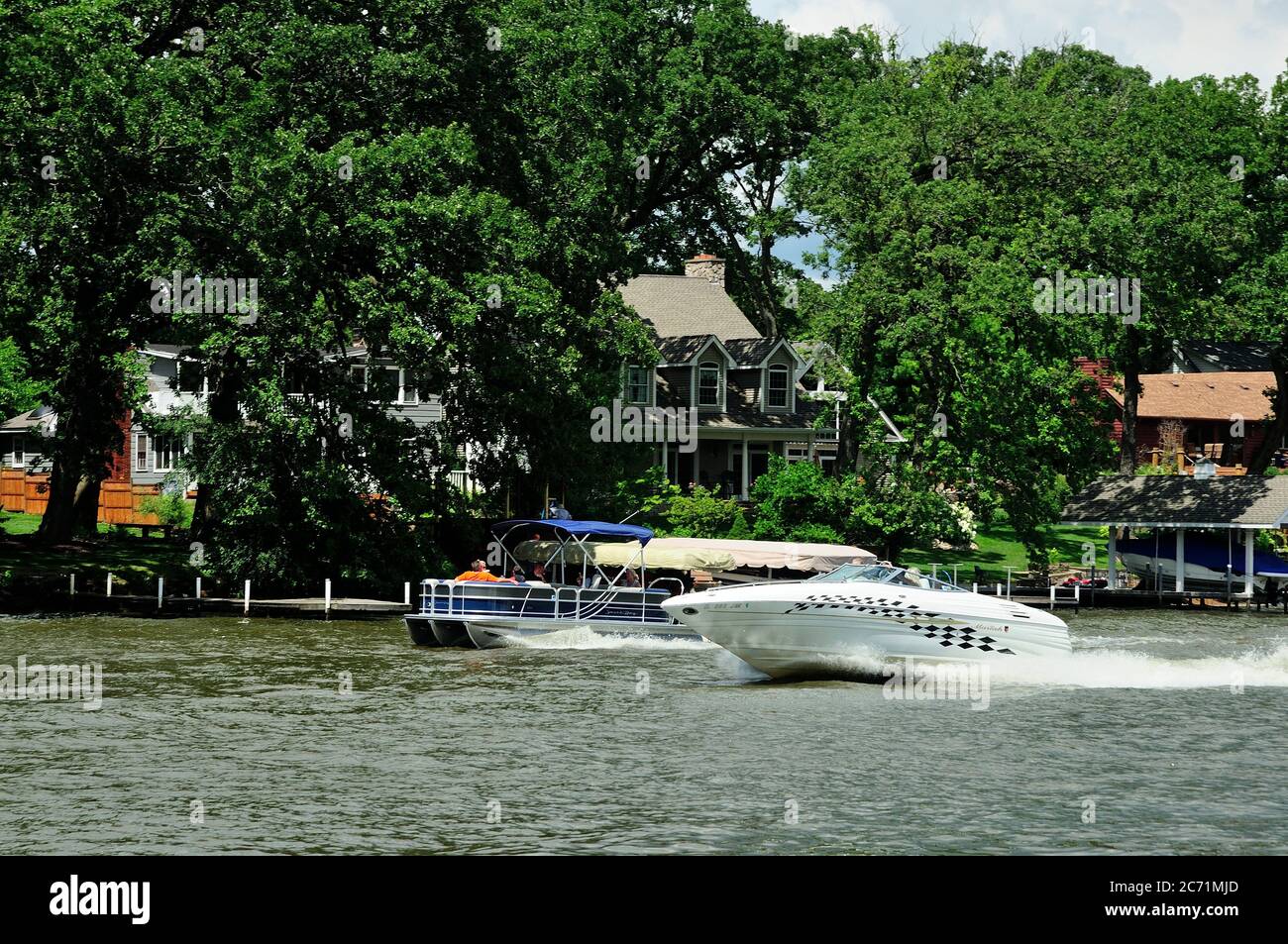 Motorboats.piiers, and boat houses along the Fox River in Northern Illinois, USA. Stock Photo