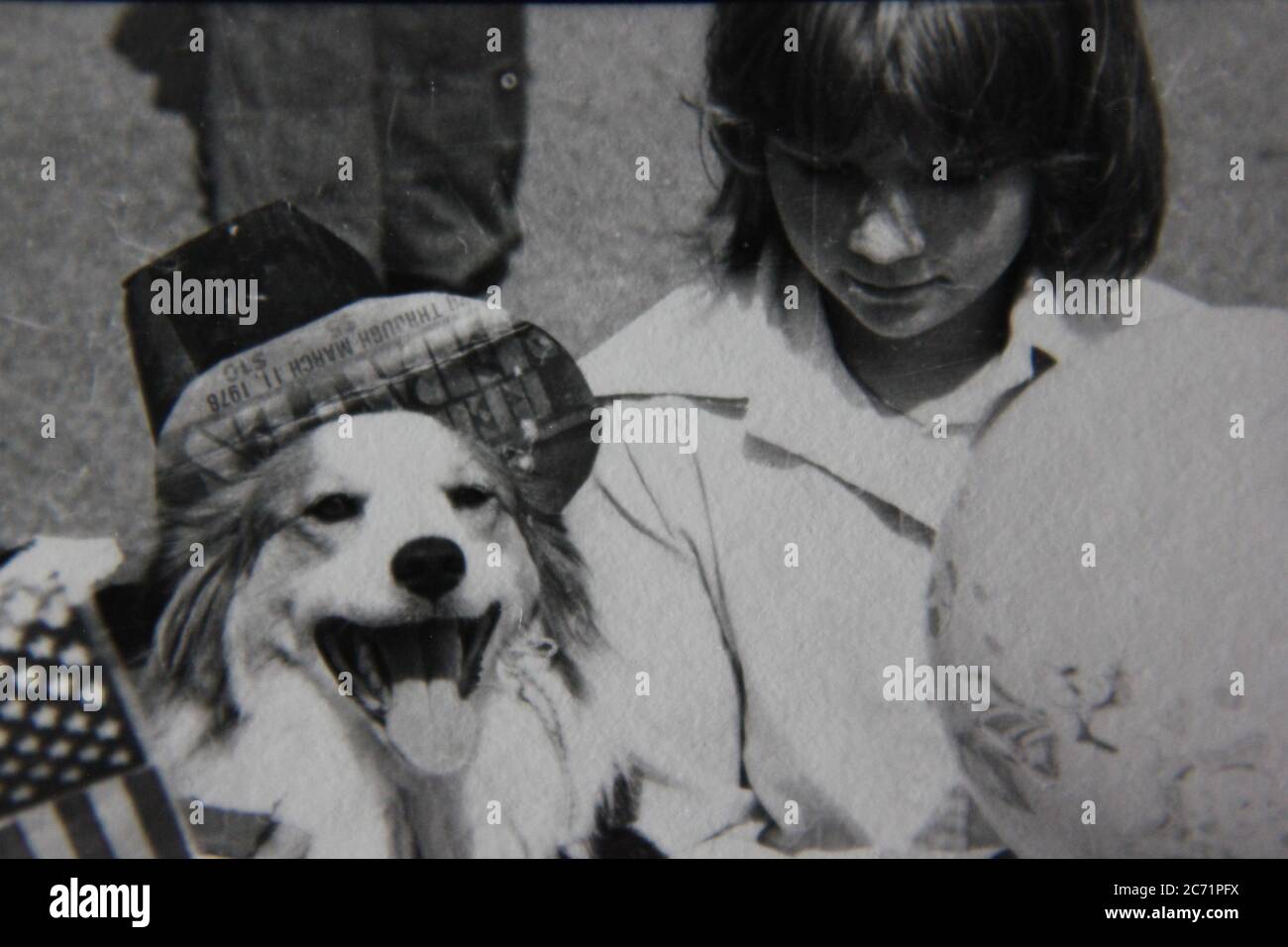 Fine 70s vintage black and white lifestyle photography of a teenage girl and her dog. Stock Photo