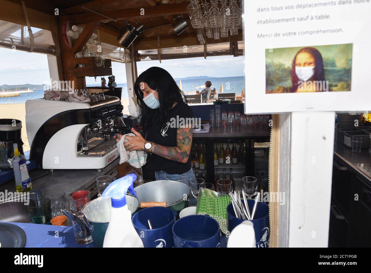STRICTLY NO SALES TO FRENCH MEDIA OR PUBLISHERS - RIGHTS RESERVED ***June  07, 2020 - La-Londe-les-Maures, France: Alyzee, a waitress at La Voile  Plage, cleans glasses at the beach restaurant La