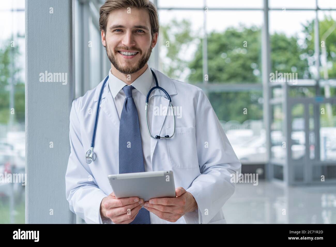 male medical doctor using tablet computer in hospital Stock Photo - Alamy