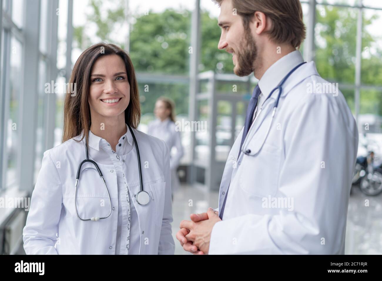 Medical Staff Having Discussion In Modern Hospital Corridor Stock Photo ...