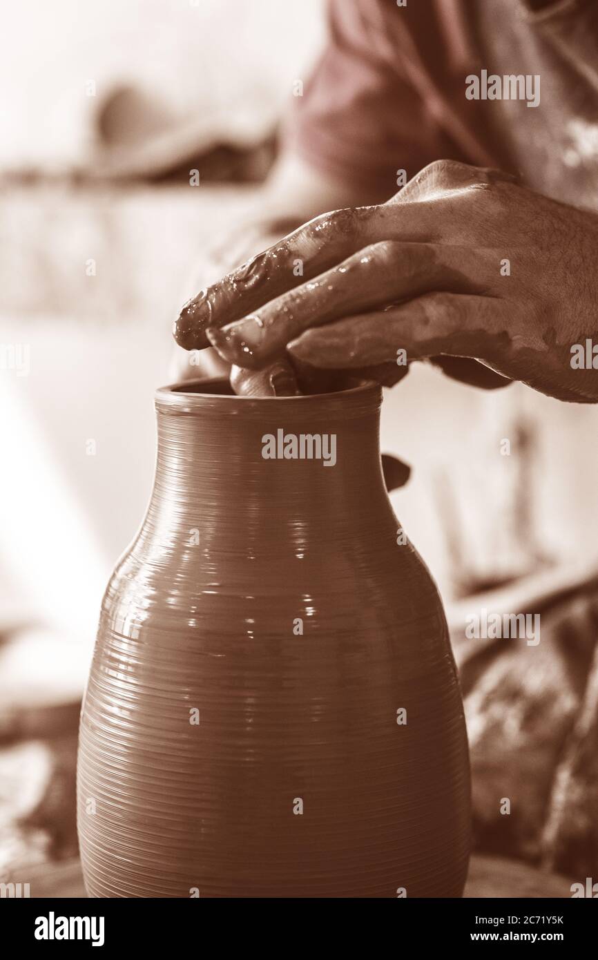 Potter hands making in clay on pottery wheel. Potter makes on the